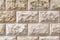 Stone background, sand wall pattern texture. Yellow natural stone facade, wall tiles.