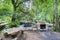 Stone barbecue and rustic wood benches and table next to the mountain river called Anllons in a typically atlantic forest in