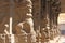 Stone bas-reliefs on the column in Shiva Virupaksha Temple, Hampi. Carving stone ancient background. Carved figures made of stone