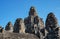 The stone of Bayon belong angkor thom nearly angkor wat is popularity of the site among tourists with blue sky in background