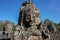 The stone of Bayon belong angkor thom nearly angkor wat is popularity of the site among tourists with blue sky in background