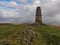 Stone beacon at the top of Latterbarrow overlooking fells, Lake District