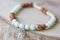 Stone bead bracelet on natural wooden background