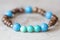 Stone bead bracelet on natural wooden background