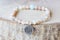 Stone bead bracelet on natural wooden background