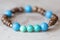 Stone bead bracelet on natural wooden background