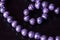 Stone beads necklace purple color on a dark background