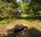 A stone bench in the shade next to the gate house in Frick Park, located in Pittsburgh, Pennsylvania, USA