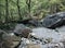 Stone blockages on the mountain river flowing through the forest