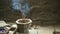 Stone bowl with incense sticks in the room of the ancient temple