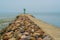 Stone breakwater with lighthouse in a small harbor