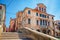 Stone brick bridge Ponte Caneva across Vena water canal and old building in historical centre of Chioggia