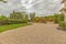 Stone brick driveway and patio with fire pit and dining area under a pavilion