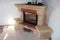 Stone and brick fireplace stands in the corner of the room where renovations are taking place.