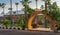 Stone bricks orange arch revealing the royal plant nursery at Montazah public park with trees and palms, Alexandria, Egypt