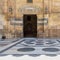 Stone bricks wall and opened door leading to passage at the courtyard of Sultan Barquq Mosque, Cairo