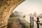 Stone bridge beautiful foggy misty canal narrow boat sunrise with smoke from chimney early morning with mist and fog rising