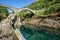 Stone bridge with clear clean green water river