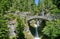 Stone bridge crosses steps of Christine falls