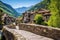 stone bridge leading to a classic mountain village