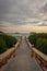 A stone bridge that leads to a place to enjoy the sunset on Royal Island, Indonesia. Surrounded by mangrove forests with beautiful