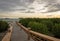 A stone bridge that leads to a place to enjoy the sunset on Royal Island, Indonesia. Surrounded by mangrove forests with beautiful