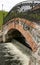 Stone bridge with metal fences over the river