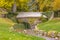 Stone bridge over a stream against lush trees