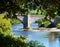 Stone bridge over sunny river