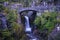 Stone Bridge And Waterfall Flowing During Spring Time