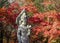 Stone Buddha Bodhisattva statue in autumn