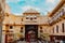 Stone building in Udaipur India surrounded by people