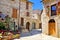 Stone buildings of the flower filled old town of Assisi, Italy