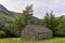 A stone built Mountain Bothy lies situated in a sheltered position within a Mountain Meadow in Glen Doll, Angus.