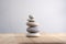 Stone cairn on striped grey white background, five stones tower, simple poise stones, simplicity harmony and balance, rock zen
