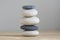 Stone cairn on wood background, stones tower, simple poise stones, simplicity harmony and balance, black and white pebbles