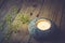 Stone candle holder with tea light on aged wood background, delicate yellow flowers