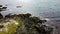 Stone cape of the coast of Ireland, top view. Rocky seashore in sunny weather. Nature of Northern Europe