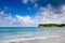 Stone cape in ocean with blue sky