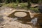 Stone carved ruin of buddhist shrine in jungles, Kbal Spean monument, Cambodia. River of 1000 lingas tourist photo