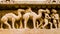 Stone carved sculpture of soldiers with camels in Kahjuraho ancient temple, India