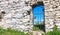 Stone castle wall with a metal passage to the courtyard