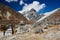 Stone cemetery surrounded by Himalayan peaks.