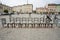 Stone chairs on cobbled street in art installation