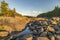 The stone channel of the river is lit by an evening sunset.