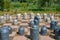 Stone chess pieces on the ground. Stylized chess Board with stone chess pieces outdoor in the park