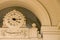 Stone clock under arch