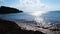 Stone coast on background of sea horizon in Sunny weather. Concept. Empty rocky coast with buoys and sun glare on water