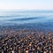 stone in the coastline sunrise and light ocean white sky