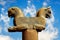 Stone column sculpture of a Griffin in Persepolis against a blue sky with clouds. Ancient Achaemenid Kingdom.